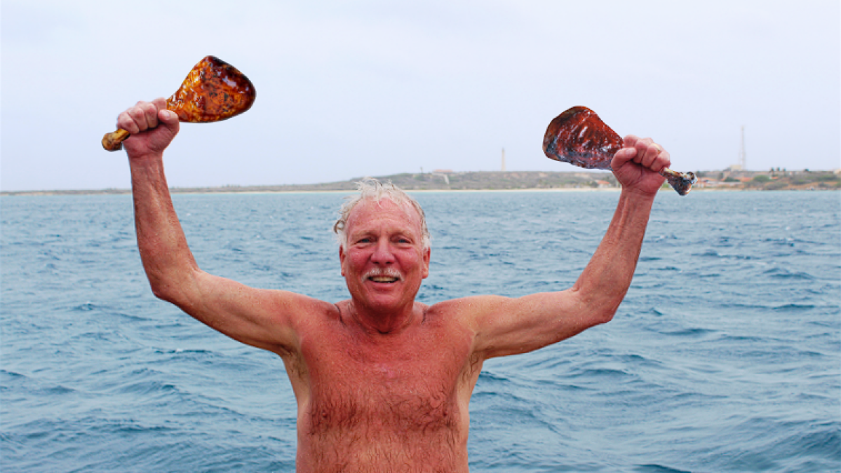 a man standing next to a body of water